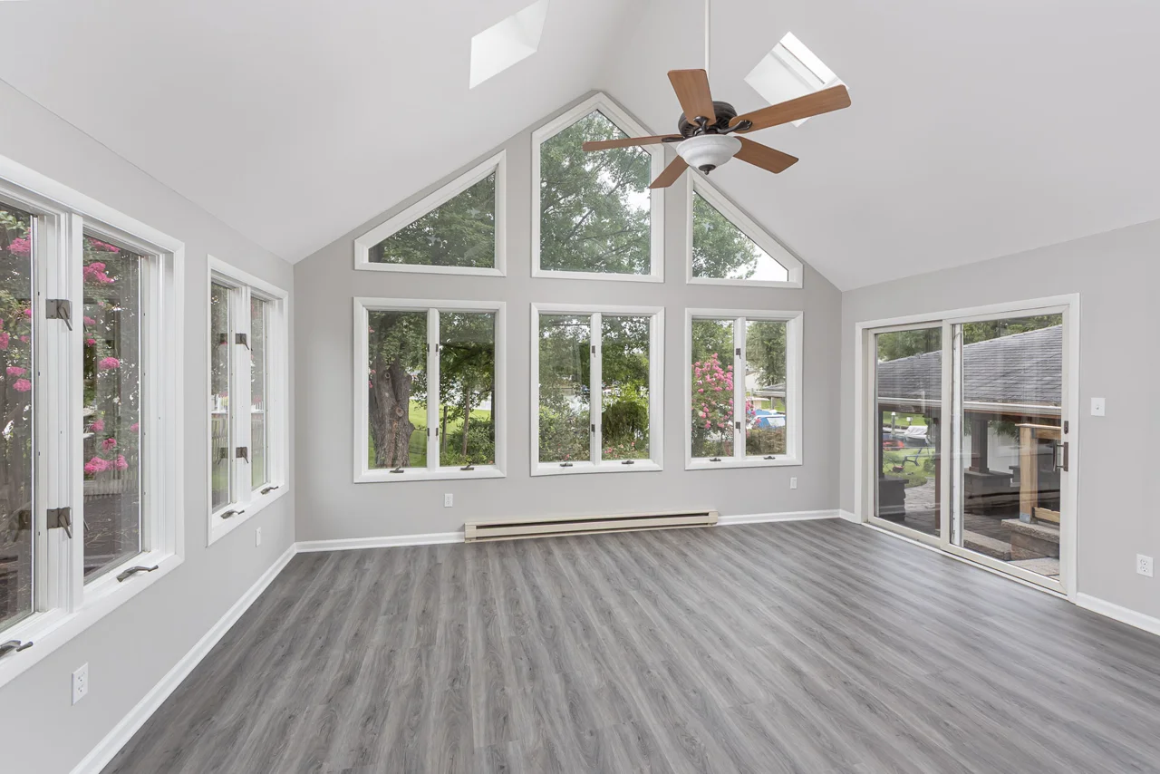 Sunroom with vaulted ceiling and tall windows