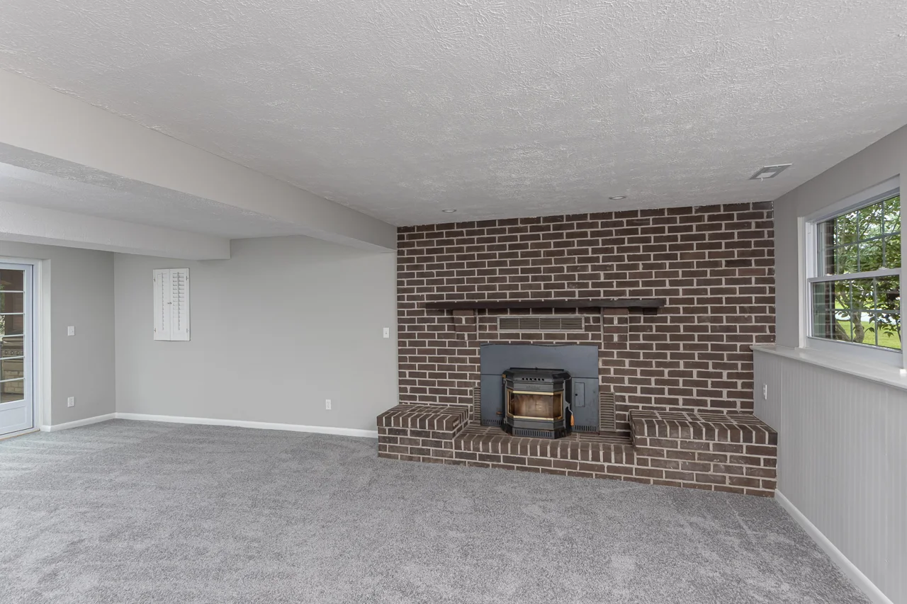 Lower-level room with brick hearth