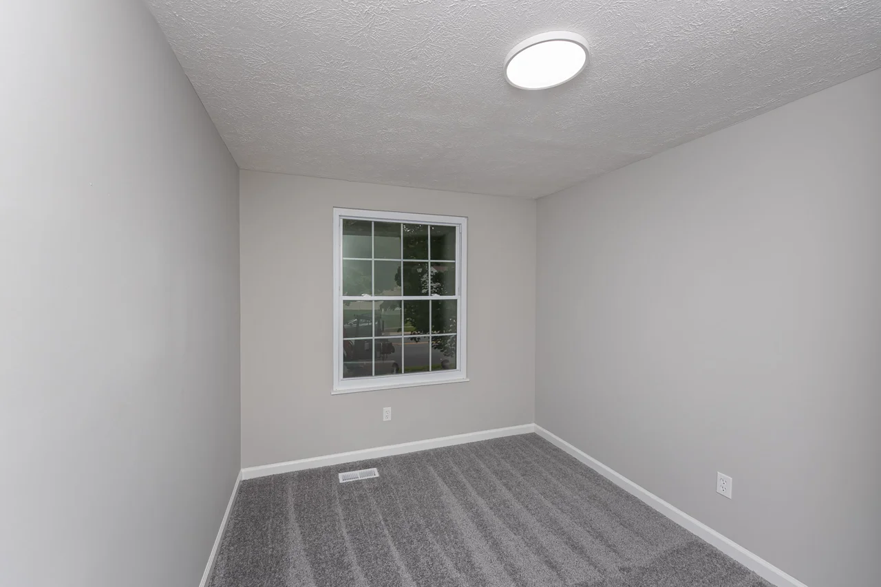 Carpeted bedroom with neutral finishes